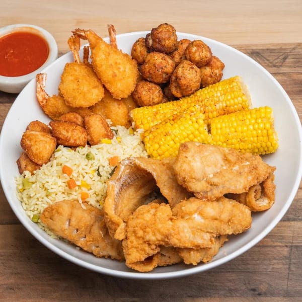 Cameron's Seafood Philly platter with fried shrimp, fish, hush puppies, rice, and corn on the cob.